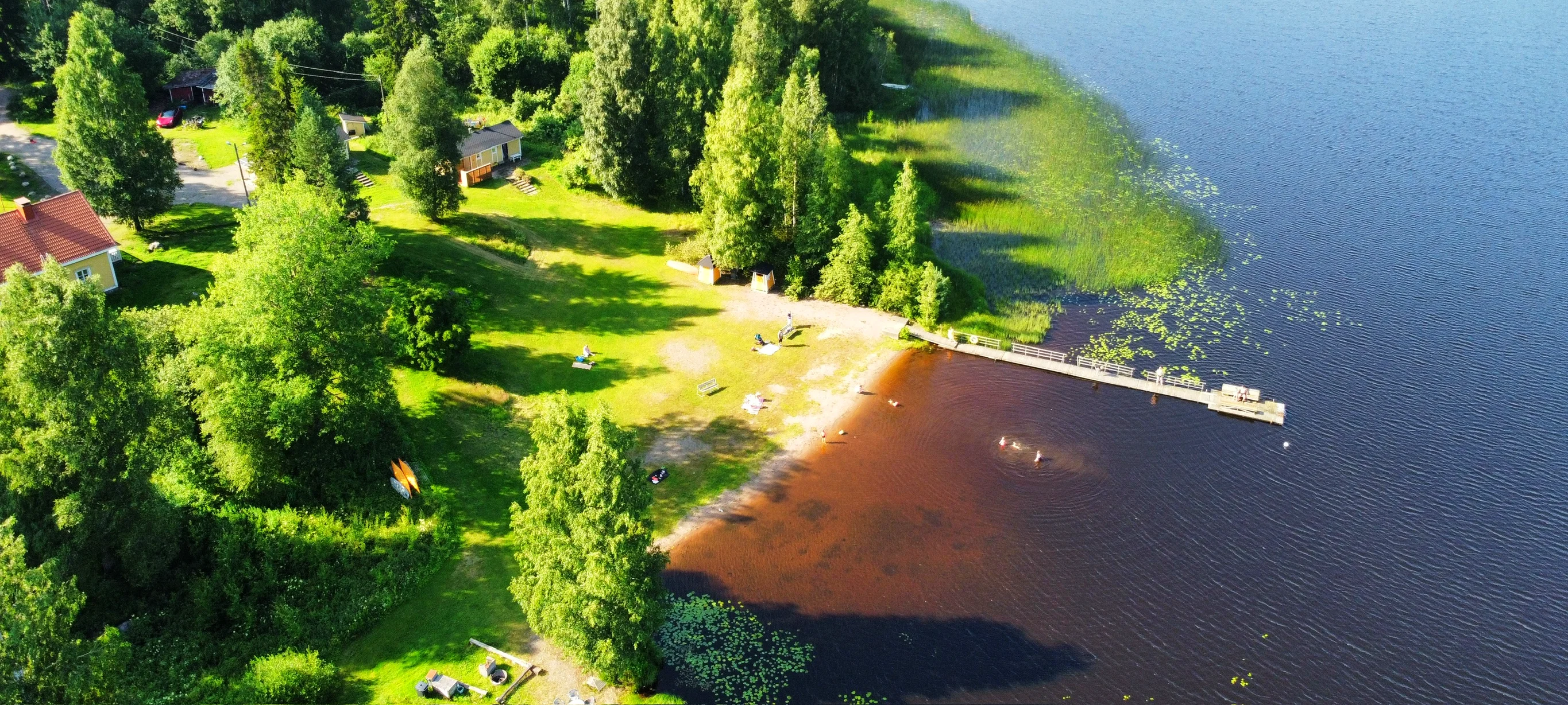 Aerial view of the lakeside sauna and swimming beach at Taika Camping